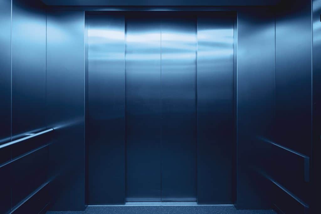 The interior of an elevator representing the employer of a senior employee who was terminated for cause