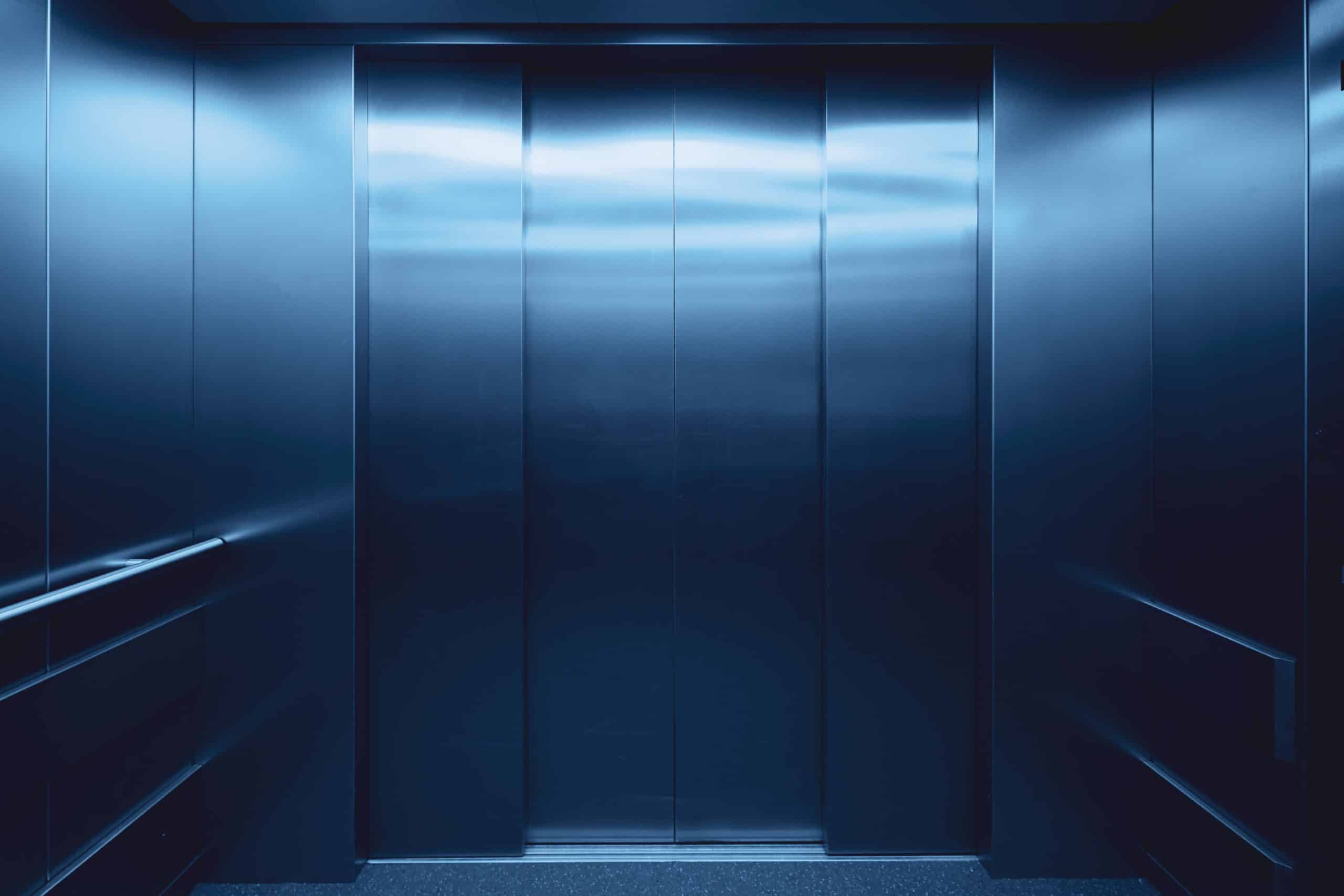 The interior of an elevator representing the employer of a senior employee who was terminated for cause