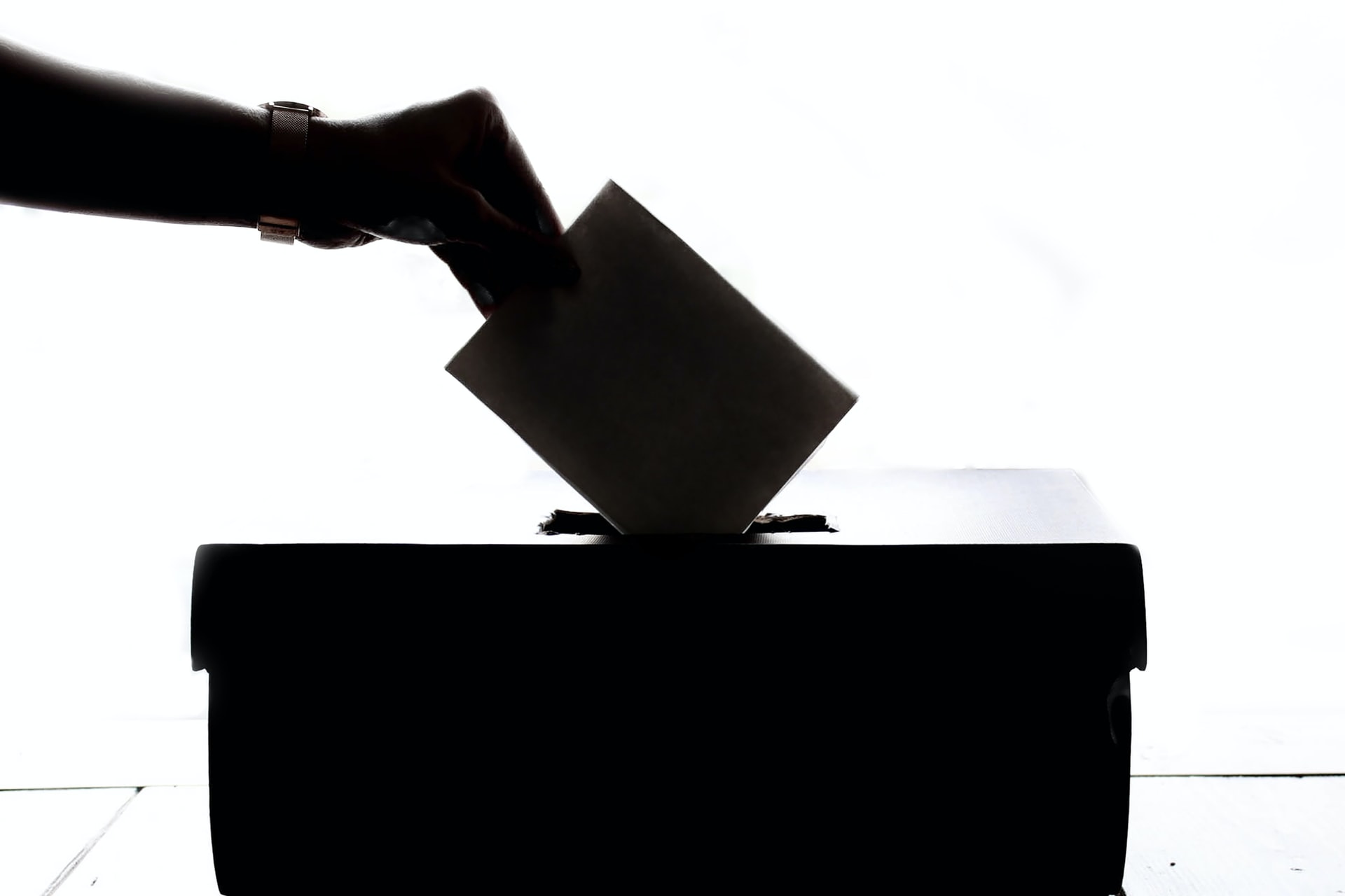 A person casting a ballot representing employer obligations with respect to time for employee voting in elections