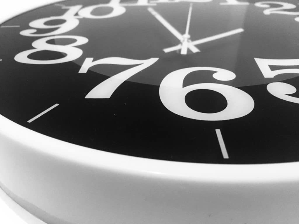 A close up of a black and white clock face representing limitation periods in employment lawsuits