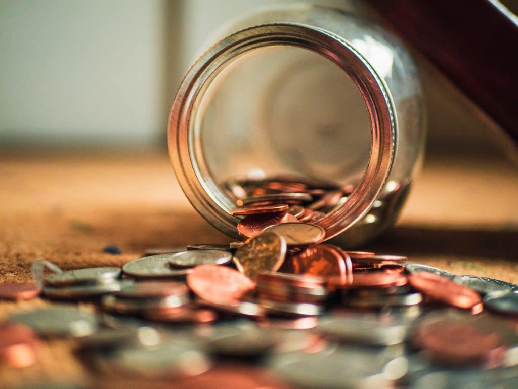 a spilled jar of coins, representing mandatory payments on termination