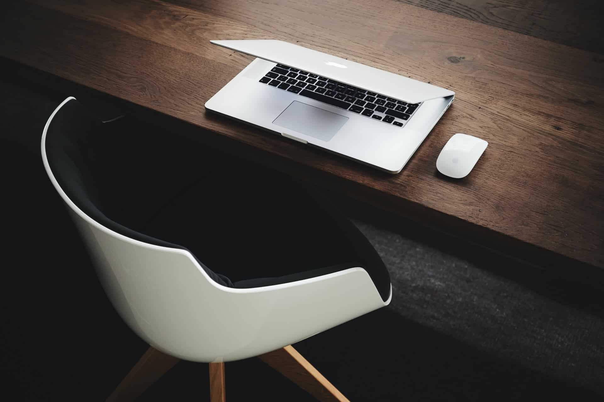 A partially closed laptop on a desk, representing snooping and breach of privacy