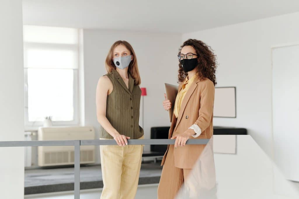 Women wearing masks at work representing a businesses right to enforce a mask mandate