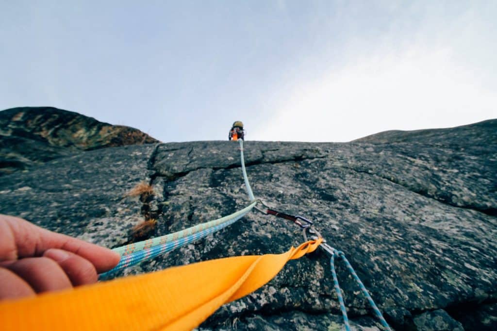 A person using supports to rock climb representing ongoing pandemic support for Canadian employees and businesses