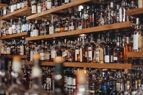 Shelves of alcohol representing alcohol and drug addiction