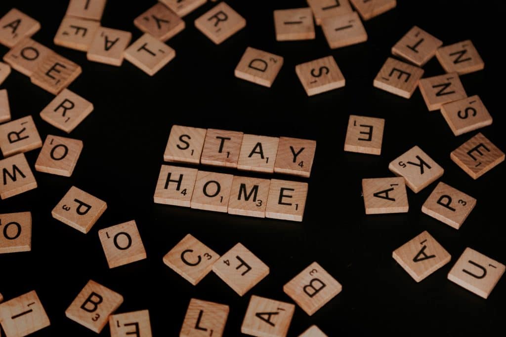 Stay Home spelled out in Scrabble tiles representing the latest employment guidelines to combat COVID infections