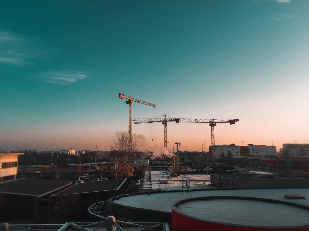 construction cranes representing a construction employee who overcame restrictive covenants in his employment contract