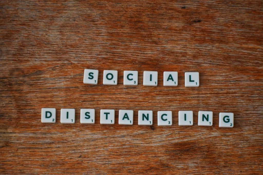 Social distancing spelled out in scrabble tiles