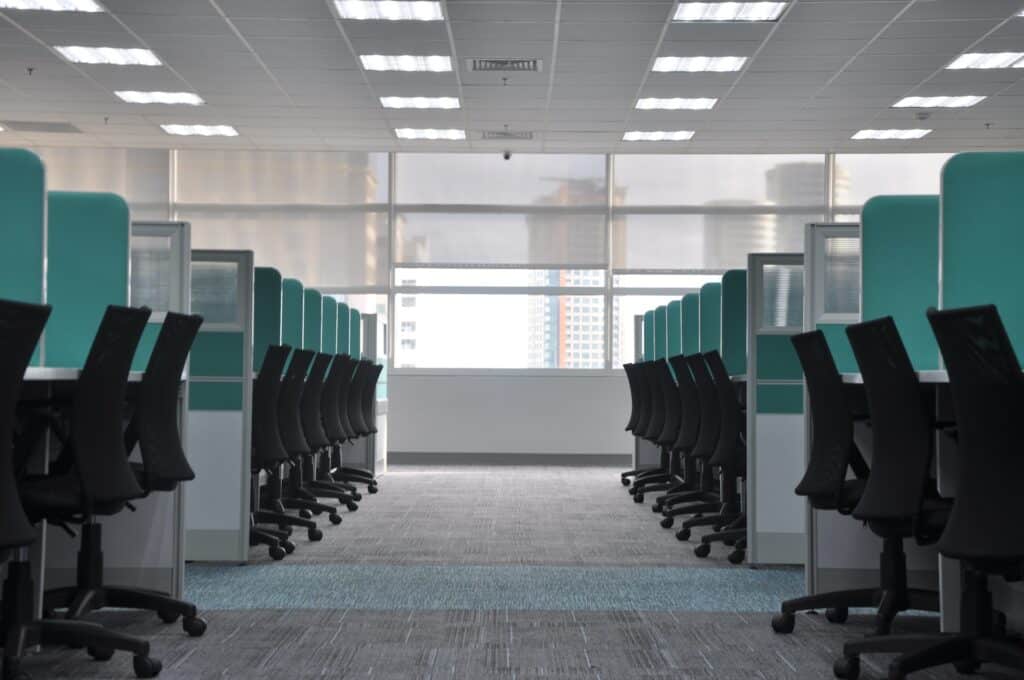 photo of empty chairs and cubicles representing reprisal by employers in the workplace