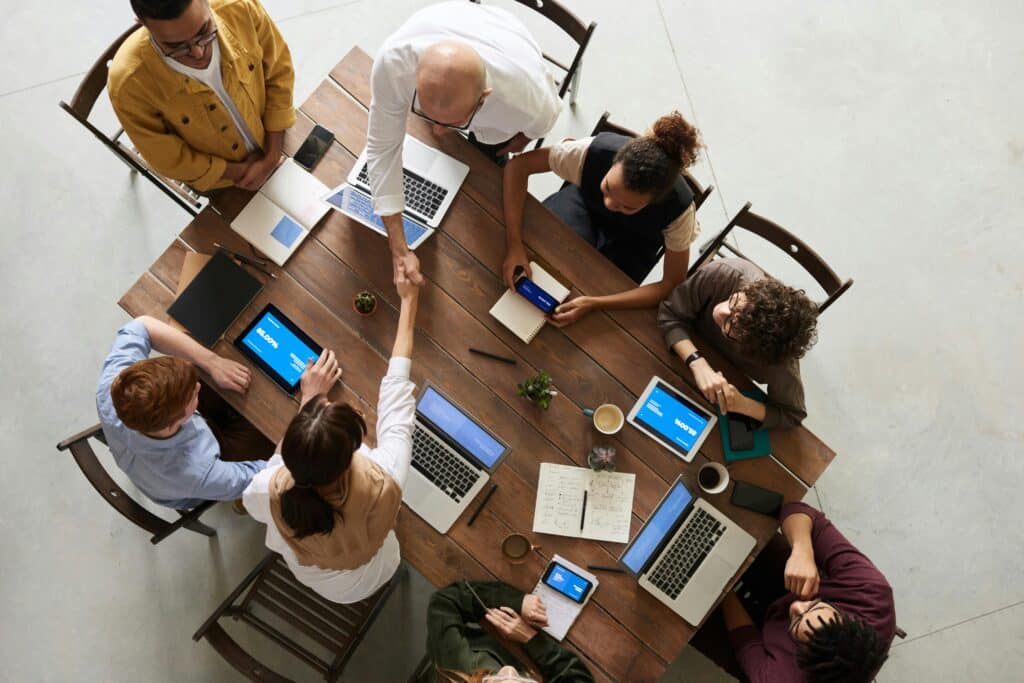 Employees sitting around a table representing workplace harassment and how to prove it