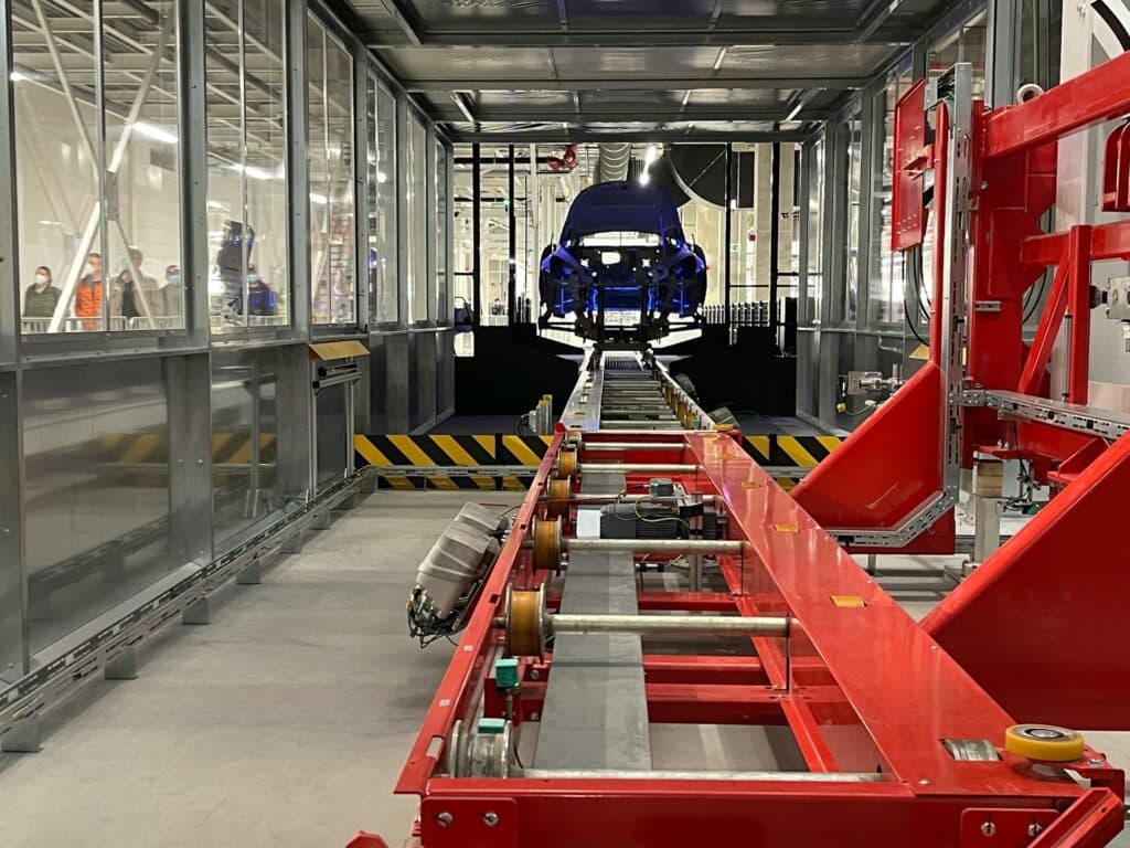 Blue car on a production line, representing mass terminations.