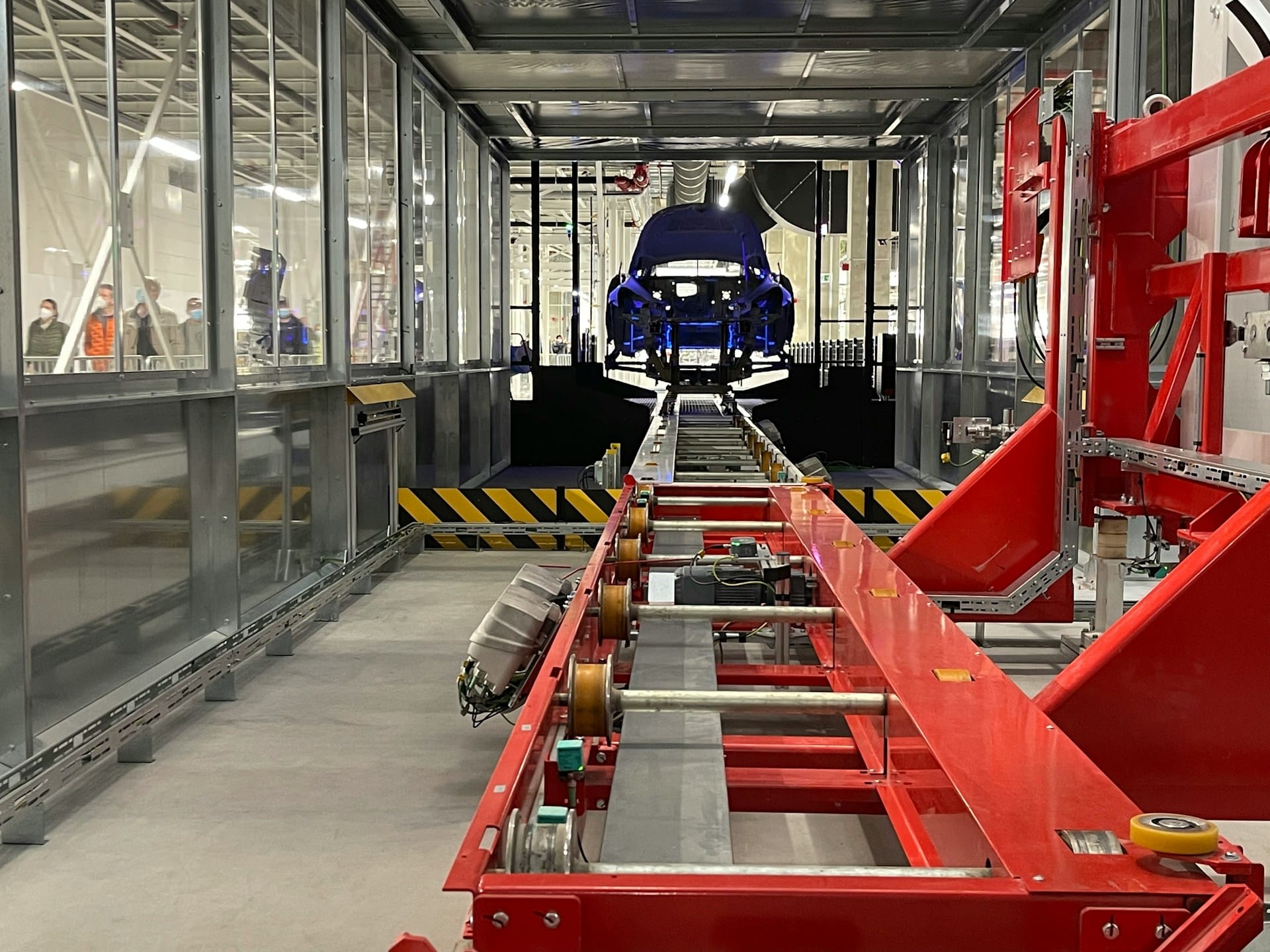 Blue car on a production line, representing mass terminations.