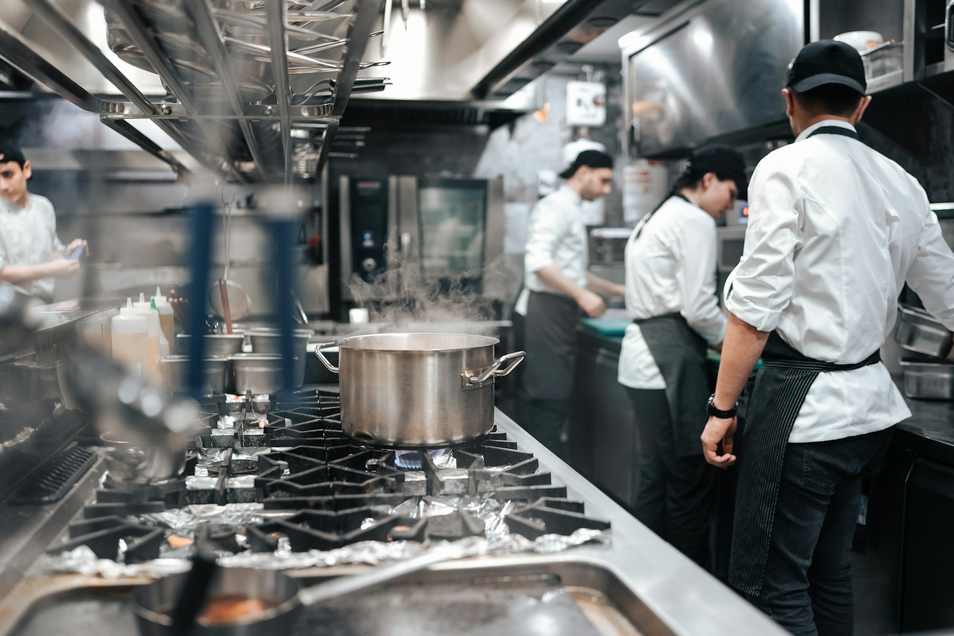 Cooks working in a busy restaurant kitchen, representing the ESA reprisal complaint decision in Sunset Grill, and Ontario Employment Standards litigation.